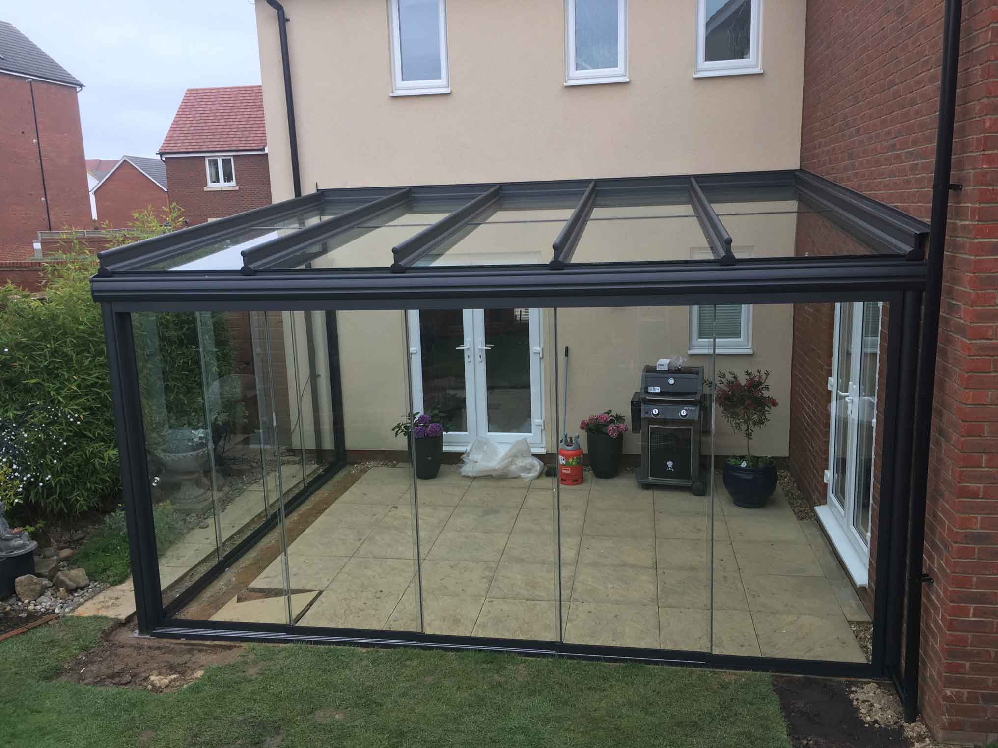 Glass room covering white patio doors.