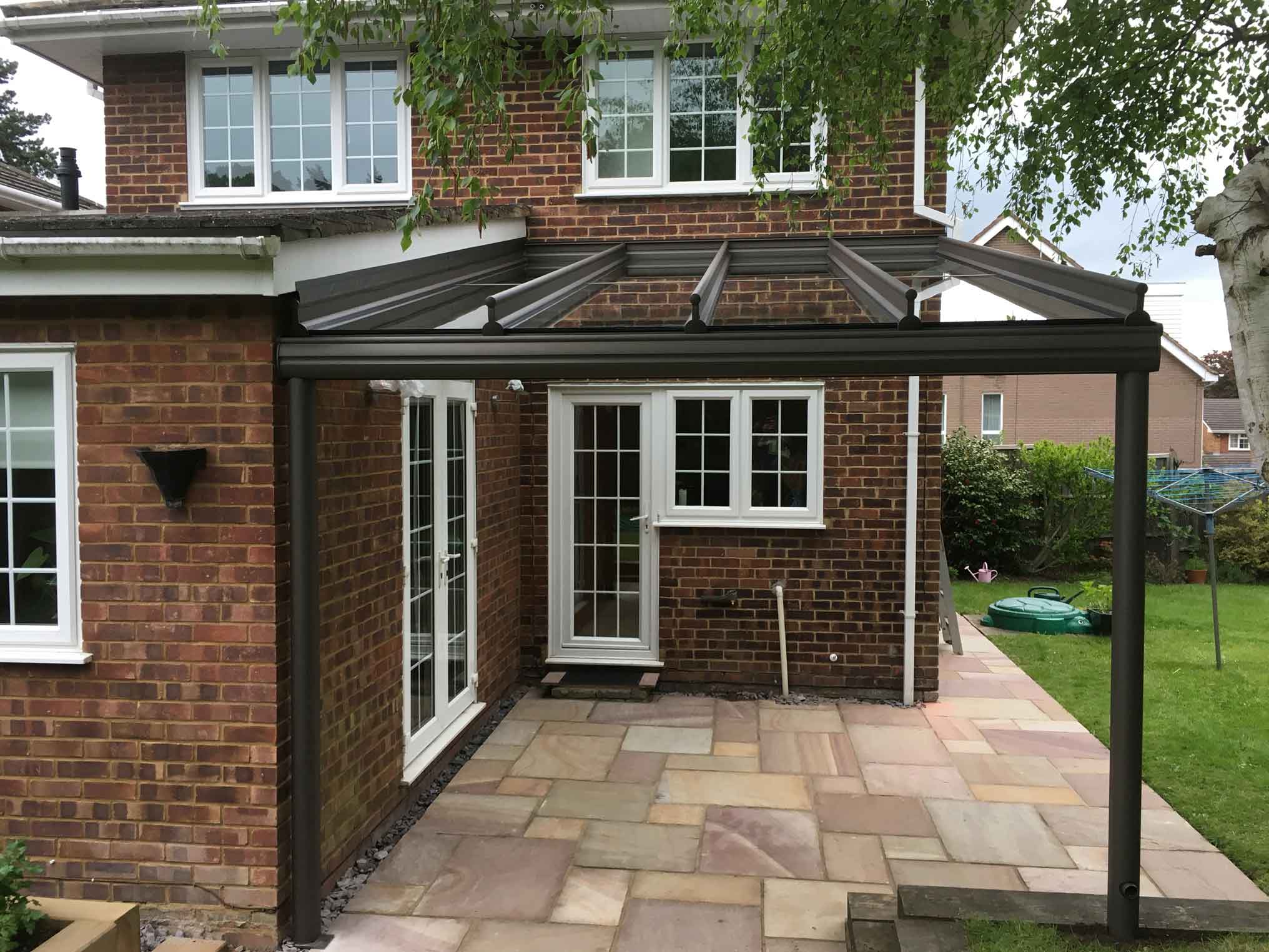 Glass roof attached to brick property.